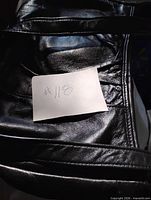 Top section showing black leather material and handle