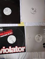 Four records laid out showing distinct sleeves and labels