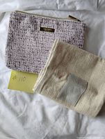 Both items side by side: tweed makeup case and folded linen bag