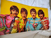 Interior gatefold portrait of The Beatles in colorful uniforms