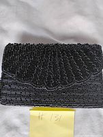 Front view showing scalloped bead pattern on flap