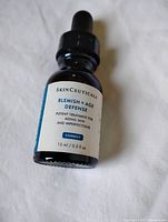 Front view of Skinceuticals Blemish + Age Defense serum bottle showing label and fill level