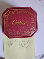 Closed Cartier box top view showing logo and gold trim