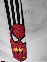 Front view of tie showing Spider-Man face and THWIP text