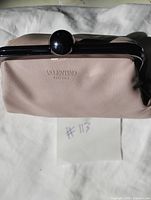 Front of blush pink Valentino Parfums cosmetic bag