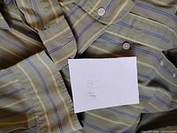 Overall view of striped shirt fabric and buttons