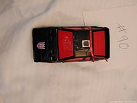 Top view of Runabout in car mode showing black body, red roof panels, purple Decepticon hood emblem