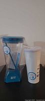 Pitcher and tumbler standing upright, new in wrap