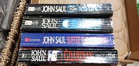 Stack of four John Saul book spines showing titles