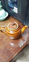 Full view of brown glazed ceramic teapot