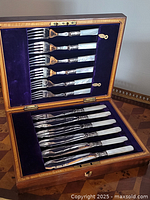 Open wood case showing full 12-piece set