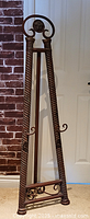 Full view of cast metal easel standing upright