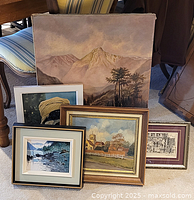 Group shot of all five artworks including large unframed mountain landscape and four framed pieces