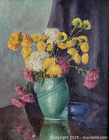 Close view of painting surface showing flowers and brushwork