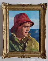 Framed oil painting showing fisherman with red hat and green coat at sea