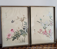 Both framed Chinese paintings side by side