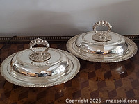 Pair of silver-plated covered entrée dishes on table