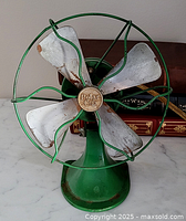 Front view showing Polar Cub badge, blades, green cage and base