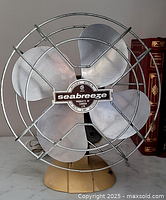 Front view of Seabreeze fan showing cage, blades, base and cord