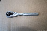 Forged steel 3/8" drive ratchet wrench stamped "FORGED IN USA"
