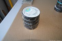 Stack of three sealed rolls with label visible