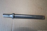 Steel chisel showing full length, striking end and flat tip