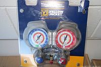 Front view sealed package showing dual gauges and manifold