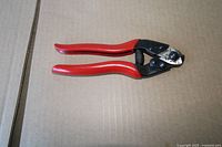 Full view of pliers closed on cardboard background