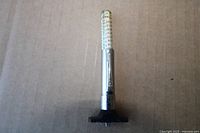 Front view of the tire tread depth gauge standing upright