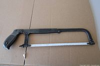 Full view of hacksaw showing frame, handle and blade