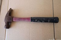 Full view of fiberglass claw hammer showing label and rust on head