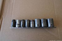 side view of eight impact sockets on rail