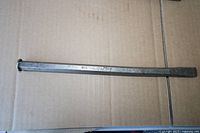 Full view of the long steel chisel on cardboard background