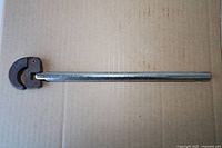 Full view of pipe wrench on cardboard background