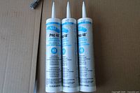 Three unopened AllPro PRO 40 sealant tubes standing upright