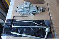 Scissor jack with three handle pieces and vinyl pouch