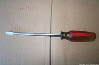 Full view of flat head screwdriver showing blade, shaft and handle