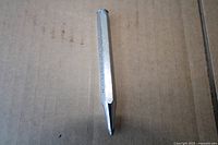 Full view of hexagonal chrome center punch showing pointed tip