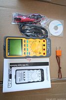 Multimeter with all accessories laid out in box