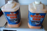 Front view of two Zep Round One hand soap jugs showing labels and contents