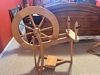 Full side view of birch single-drive spinning wheel showing drive wheel, treadle and flyer