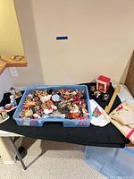 Overall view of tote filled with ornaments and additional decor pieces on table