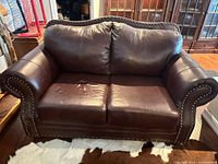 Front view of dark brown leather loveseat