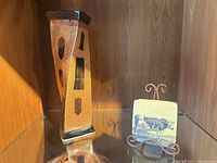 Ceramic vase beside tile coaster on metal stand