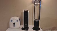 Homedics humidifier, Profusion heater, Dyson fan lined side by side