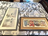 Overall view of both framed prints on bed
