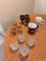 All glassware and mugs laid out on table
