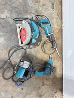 All four Makita corded tools laid out: circular saw, reciprocating saw, jigsaw, drill