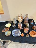 All 17 ceramic pieces grouped on black cloth