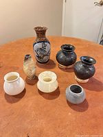 Group shot of all seven vases on table